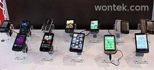 A photo of a group of 10 smart phones on display